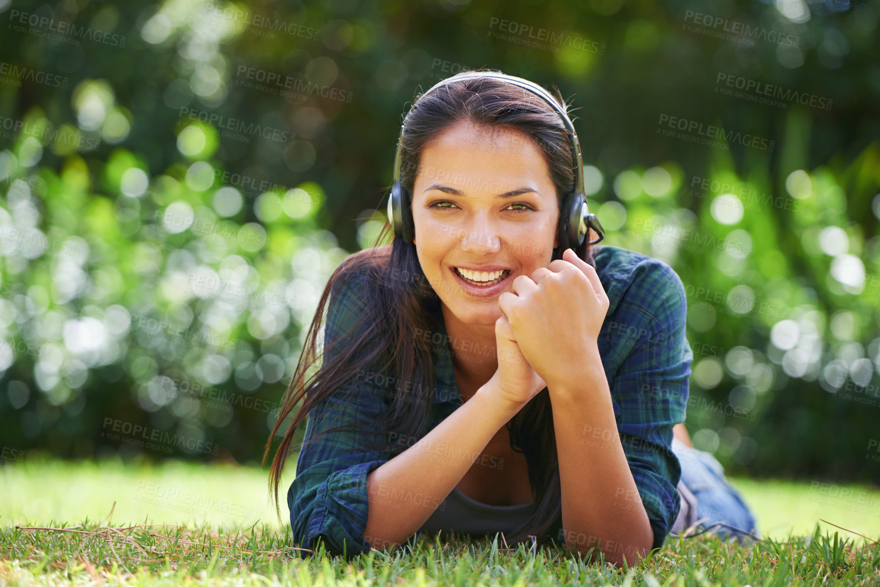 Buy stock photo Music, headphones and relax for girl on grass outdoor in garden, lawn or forest for podcast, sound or streaming. Young person and smile with gadget in nature or tranquil environment in spring