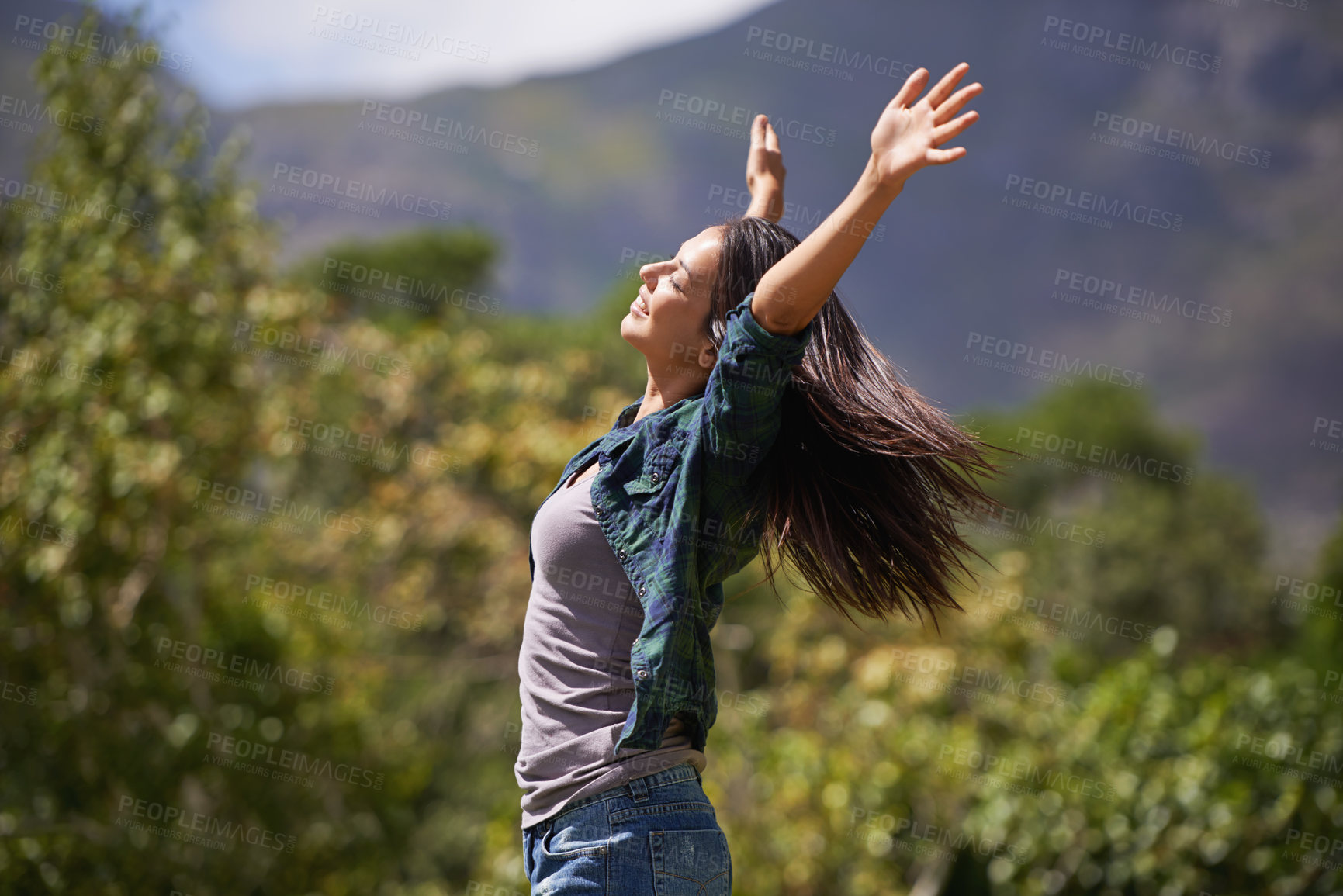Buy stock photo Freedom, wellness and hands raised with young woman relax in garden for enthusiasm or inspiration. Nature, park and smile with happy person outdoor at park in summer for energy or excitement