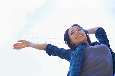 Buy stock photo Happy, sky and arms with a woman outdoor in nature for fun, freedom or adventure in summer from below. Smile, financial freedom and wellness with a young female person outside for peace or dance