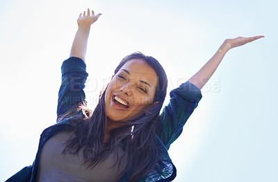 Buy stock photo Portrait, celebrate life and arms with a woman outdoor in nature for fun, freedom or adventure in summer from below. Smile, clear sky and wellness with a happy young person outside during the day