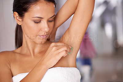 Buy stock photo Shot of a young woman waxing her under arm