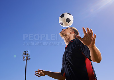 Buy stock photo Shot of a young footballer bouncing a ball on his head