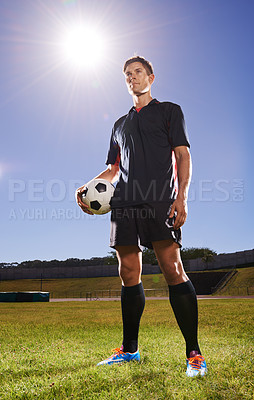 Buy stock photo Man, field and training with soccer ball for workout or practice for game with fitness and tournament in Belgium. Male person, player and exercise for sport or football career with warm up for match