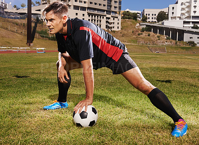 Buy stock photo Man, field and football for training with workout or practice for match with fitness and competitive in France. Male person, player and exercise for sport or soccer career with warm up for game.