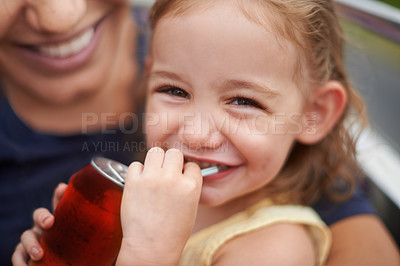 Buy stock photo Portrait of a little girl drinking a soda on her mothers lap