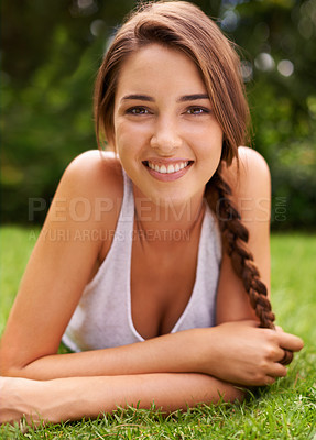 Buy stock photo Woman, portrait and smile on grass for relax with sunshine, enjoyment or weekend break in summer. Young person, happiness or confident on lawn, garden or backyard of home for fresh air in environment