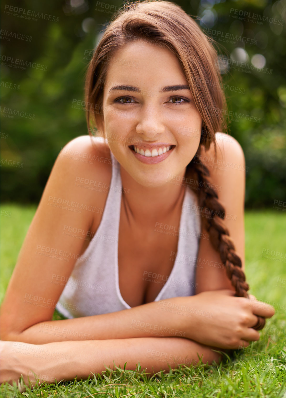 Buy stock photo Woman, portrait and smile on grass for relax with sunshine, enjoyment or weekend break in summer. Young person, happiness or confident on lawn, garden or backyard of home for fresh air in environment