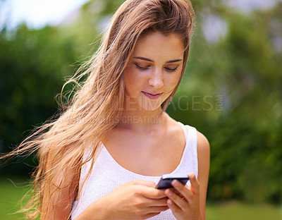 Buy stock photo Phone, nature and young woman in park networking on social media, app or internet. Smile, technology and female person scroll on website with cellphone for communication in outdoor field or garden.
