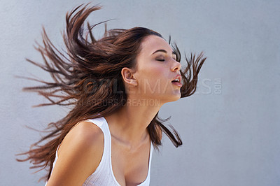 Buy stock photo Woman, hair or shake as hairdressing, hairstyle or promo of healthy, texture or growth for scalp. Wind, long or natural style as grooming in maintenance, shine or volume in studio on grey background