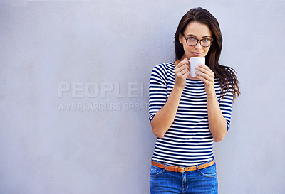Buy stock photo Portrait of a an attractive woman holding a coffee cup against a gray background