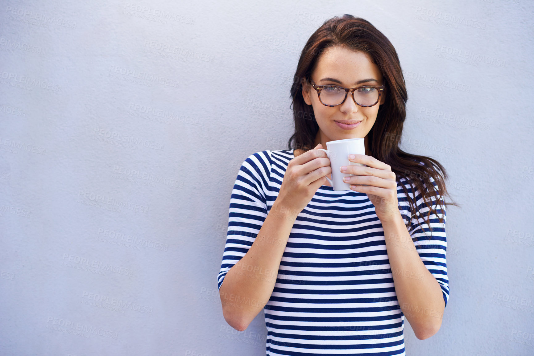 Buy stock photo Portrait of a an attractive woman holding a coffee cup against a gray background