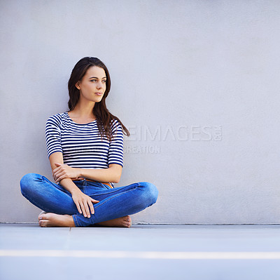 Buy stock photo Thinking, woman and style on floor for leisure with casual outfit for fashion or comfort, relax and wellness with smile. Female person, isolated with grey background or wall for clothing with mockup.