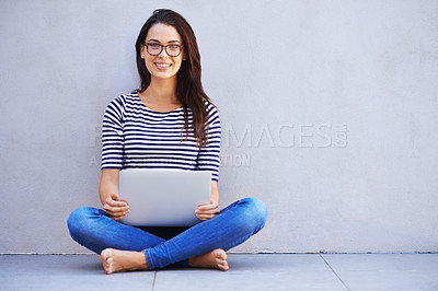 Buy stock photo Full-length shot of an attractive young woman sitting with her laptop