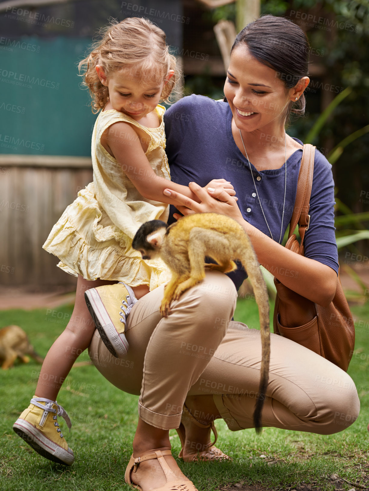 Buy stock photo Shot of a young mother and her daughter at a monkey sanctuary