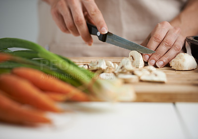 Buy stock photo Cooking, food and hands with vegetables in kitchen on wooden board for cutting, meal prep and nutrition. Healthy diet, ingredients and person with mushrooms for vegetarian dinner, lunch and salad