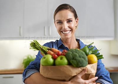 Buy stock photo A young woman with vegetables in the kitchen