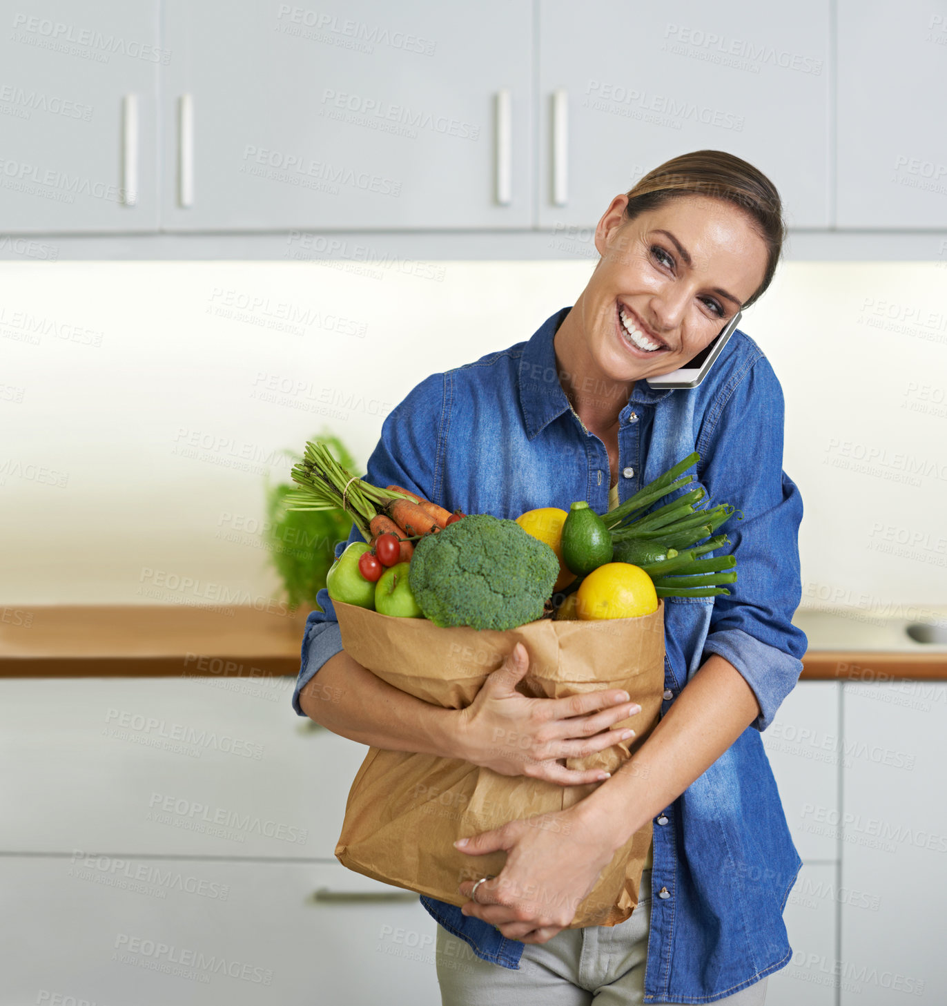 Buy stock photo Happy woman, grocery bag and phone call with vegetables for conversation, communication or shopping at home. Female person, customer or shopper smile on mobile smartphone for ingredients in kitchen