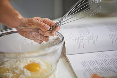 Buy stock photo Hands, person and whisk with bowl, kitchen and cookbook for baking. Baker, muffin or food with countertop, eggs and flour for recipe preparation and recreation or hobby at home or house with utensils