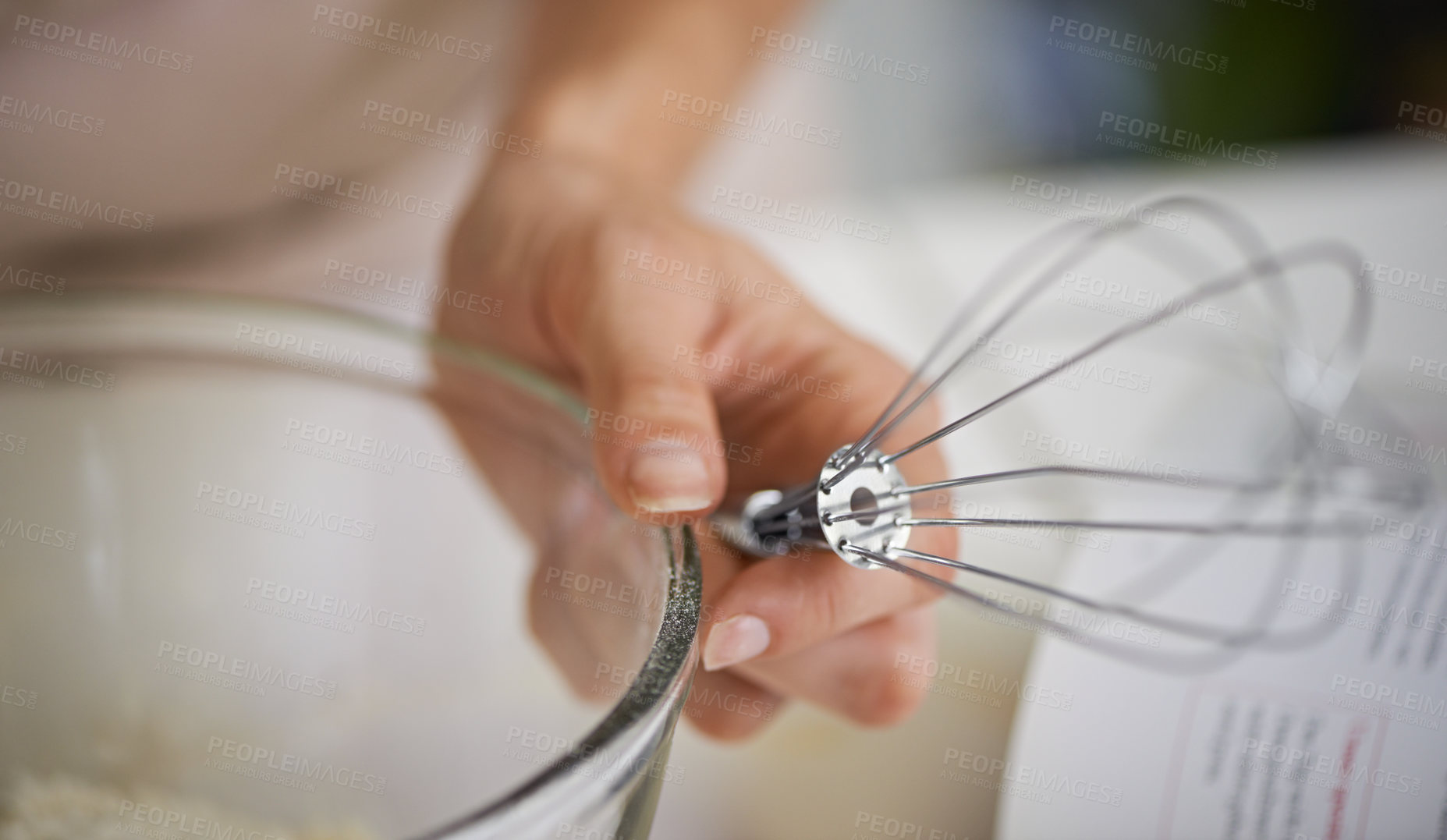 Buy stock photo Hands, person and whisk with cookbook, kitchen and bowl for baking. Baker, muffin or pastry and food with countertop, apron and cooking for recipe preparation and recreation or hobby at home or house
