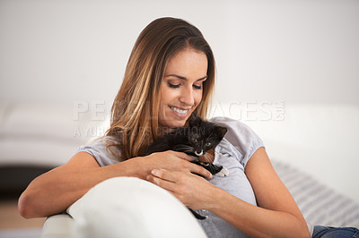 Buy stock photo Kitten, woman and smile on couch for animal or pet for cute and adorable in hands for play and friends. Young person and relax with cat for paw and scratch with gentle, care and touch for love  