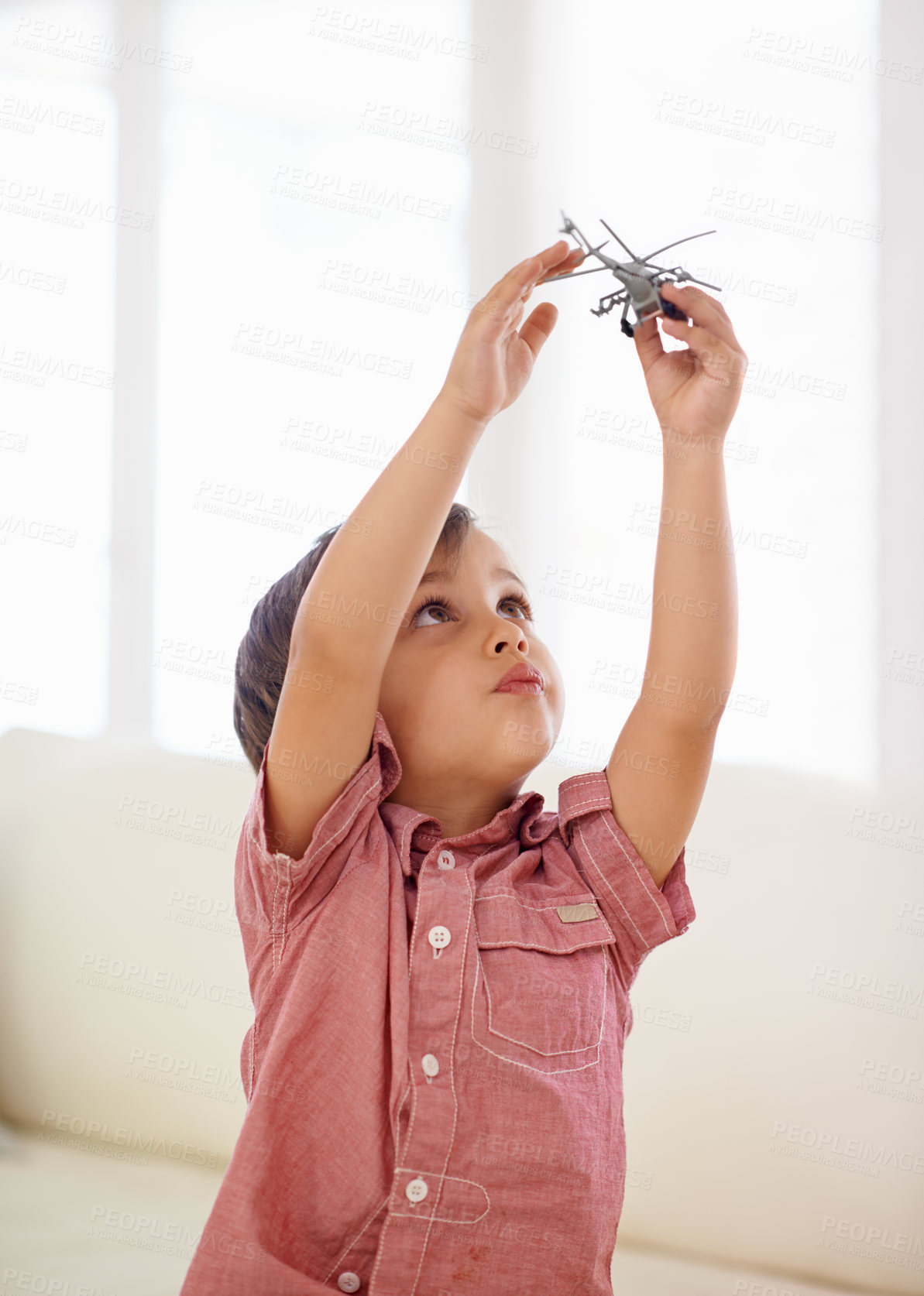 Buy stock photo A little boy playing with a toy helicopter