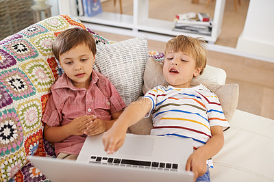 Buy stock photo Laptop, kids and siblings on sofa for cartoon, film or streaming movie at home. Computer, learning or boy children in house for google it, search or hand pointing to video, show or Netflix and chill