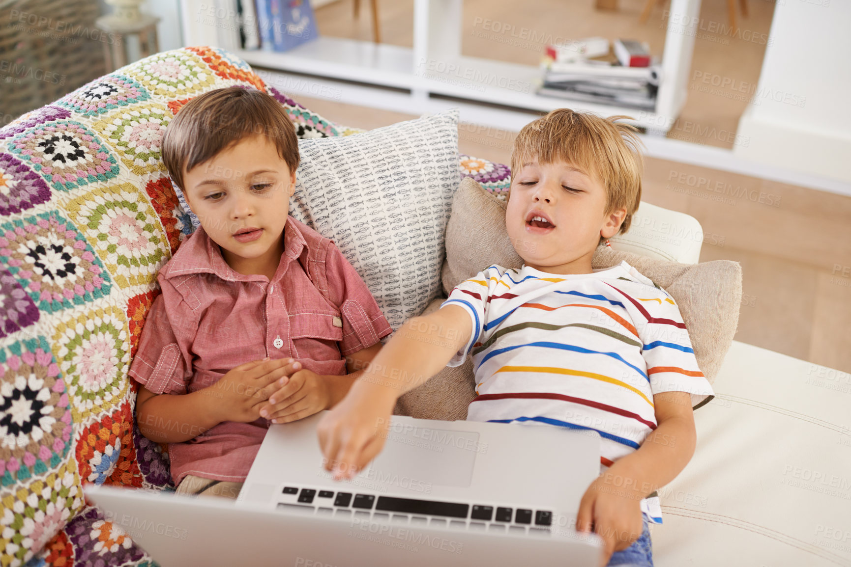 Buy stock photo Laptop, kids and siblings on sofa for cartoon, film or streaming movie at home. Computer, learning or boy children in house for google it, search or hand pointing to video, show or Netflix and chill