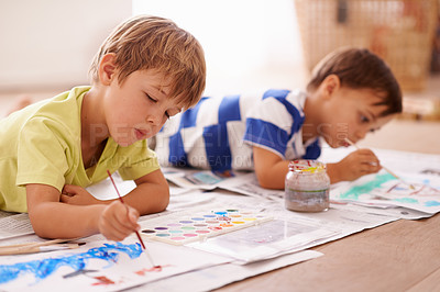 Buy stock photo Shot of two young boys painting pictures at home