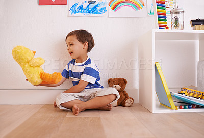 Buy stock photo Child, toy and play with teddy, smile and happiness for fun and joy at home or daycare. Boy, cute and positive with stuffed animal, laugh and childcare for growth and cheerful on wood floor in house
