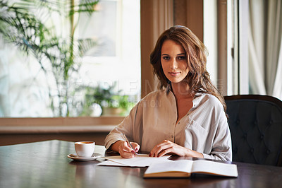 Buy stock photo Portrait of an attractive young woman writing in a relaxed environment at home