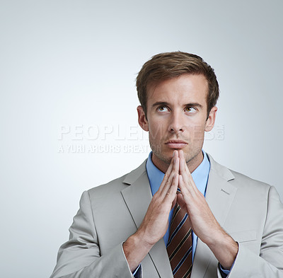 Buy stock photo Businessman, serious and thinking in grey background of studio with professional in suit. Male person, brainstorming and hands together for ideas, corporate and working as employee in company 