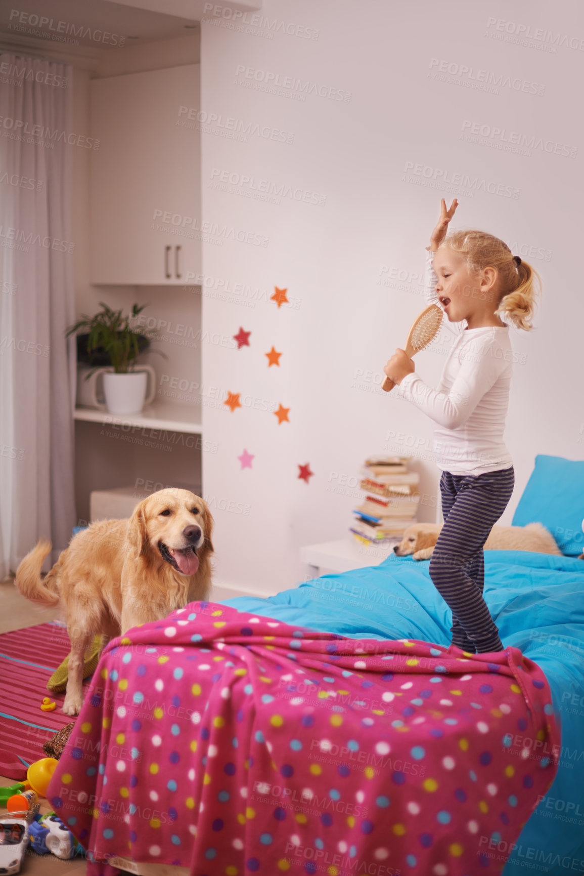 Buy stock photo Girl, child and puppy with playing on bed for karaoke, bonding and singing in bedroom of home with brush. Kid, golden retriever and dog for companion, dancing and relax with pet care in apartment
