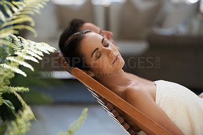 Buy stock photo Cropped shot of a mature couple relaxing side by side on lounge chairs outside