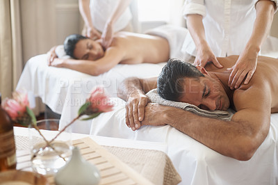 Buy stock photo Spa, back massage to relax and couple with masseuse for luxury pamper treatment together. Beauty, wellness or therapy with mature husband and wife at resort or salon for natural stress relief