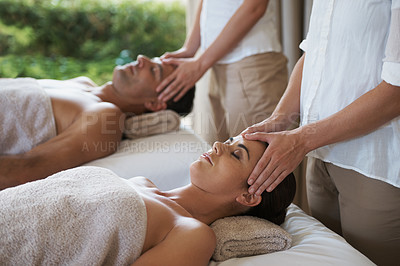 Buy stock photo Facial, head massage and couple in spa to relax on bed for luxury pamper treatment together in hotel. Beauty, hands or zen woman with man at resort or salon for natural healing benefits or skincare