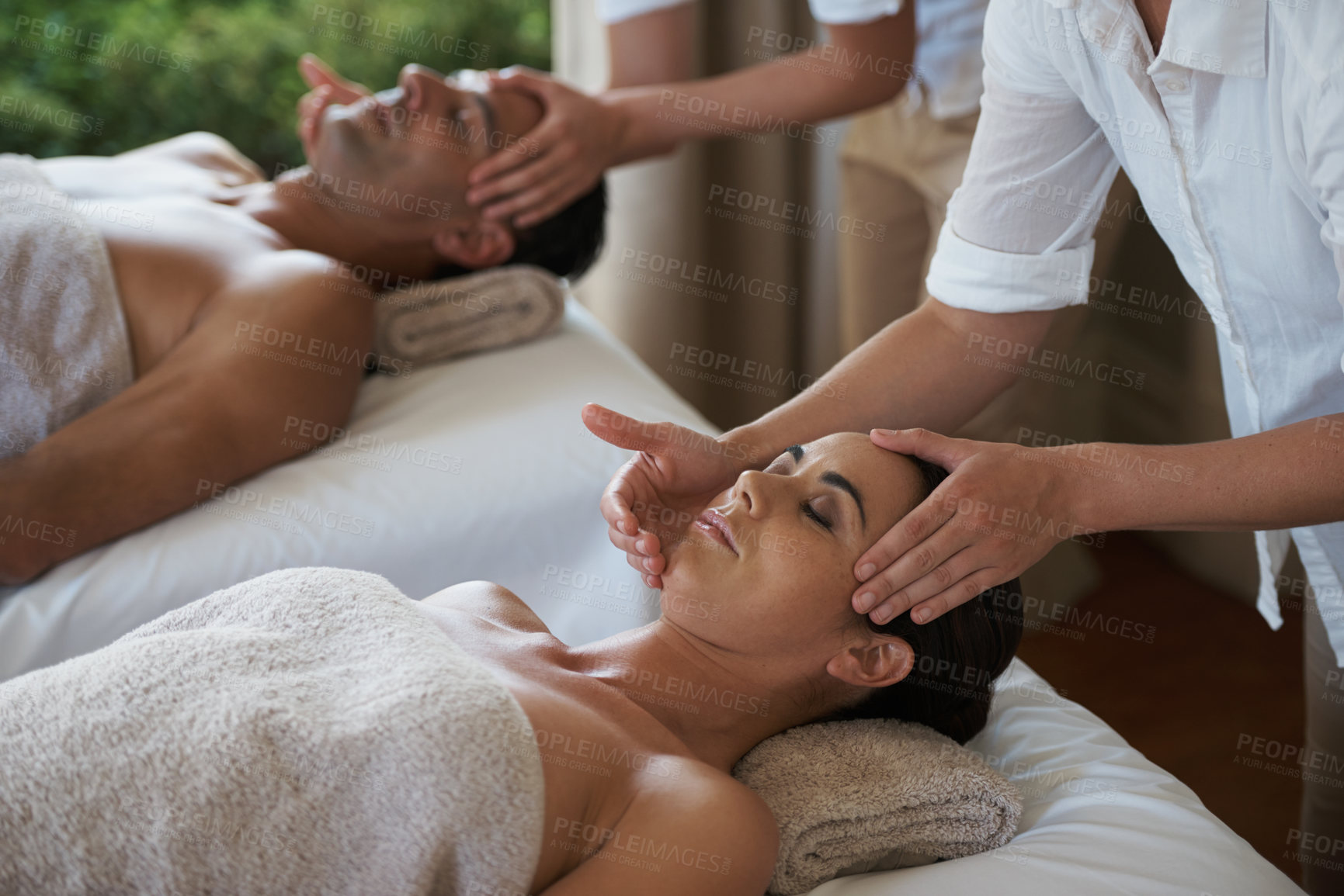 Buy stock photo Holiday, head massage and couple relax in spa for care of body with rest on table of retreat for honeymoon. Hotel, man and woman together in resort for health, wellness and luxury  for skincare
