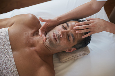 Buy stock photo Hands, face massage and top view of man at salon for skincare, peace and calm at luxury resort at table for wellness. Above, therapy and masseuse at spa for head treatment, health and person relax