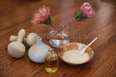Buy stock photo Massage ball, herbal or aromatherapy with flowers, oil for spa, calm or peace to relax for natural healing. Protea plant, wellness or bowl for wellbeing, holistic treatment or hospitality background