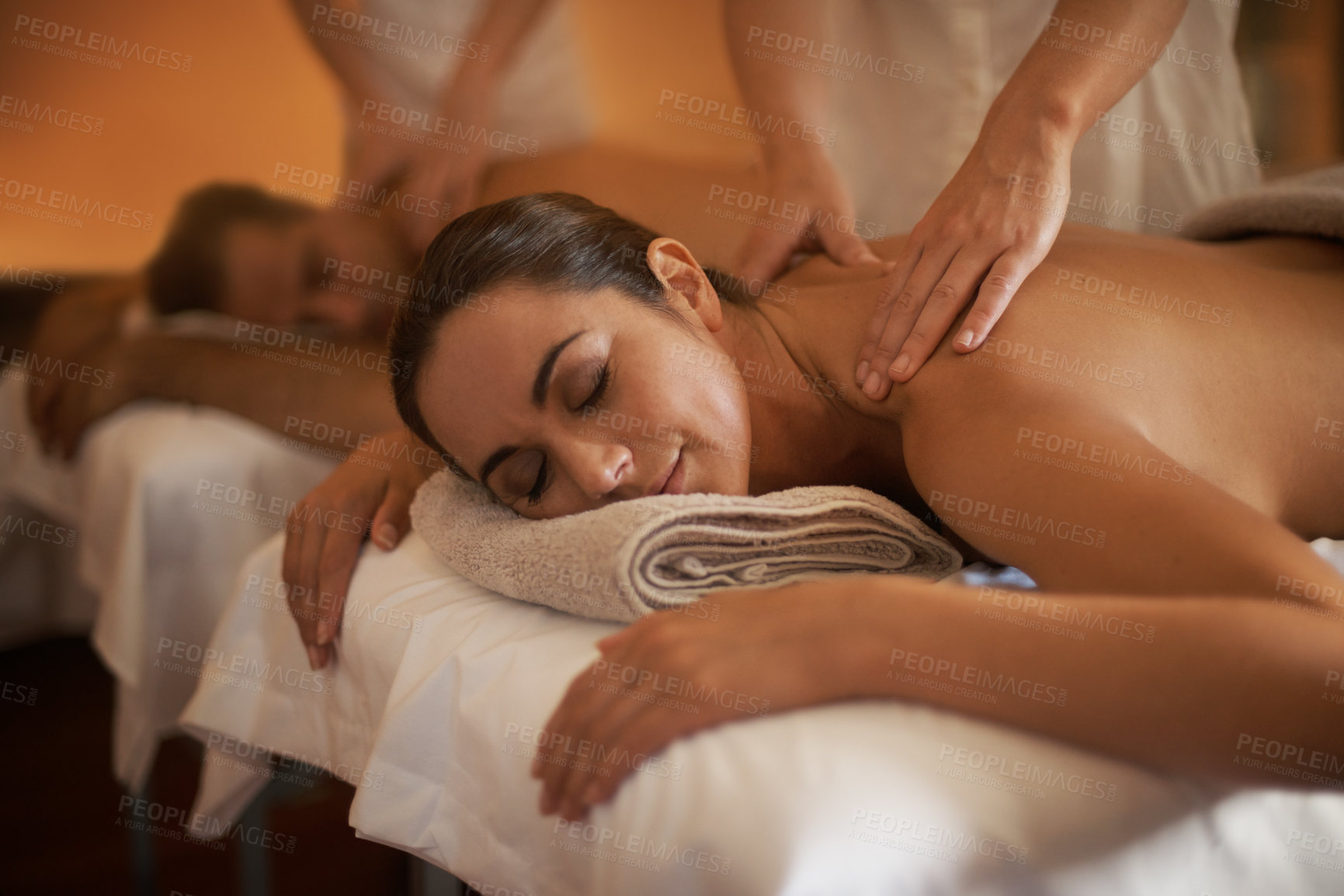 Buy stock photo Hands, back massage or calm couple in spa to relax on bed for luxury pamper treatment together in hotel. Beauty, sleep or zen woman with man at resort or salon for natural healing benefits or body