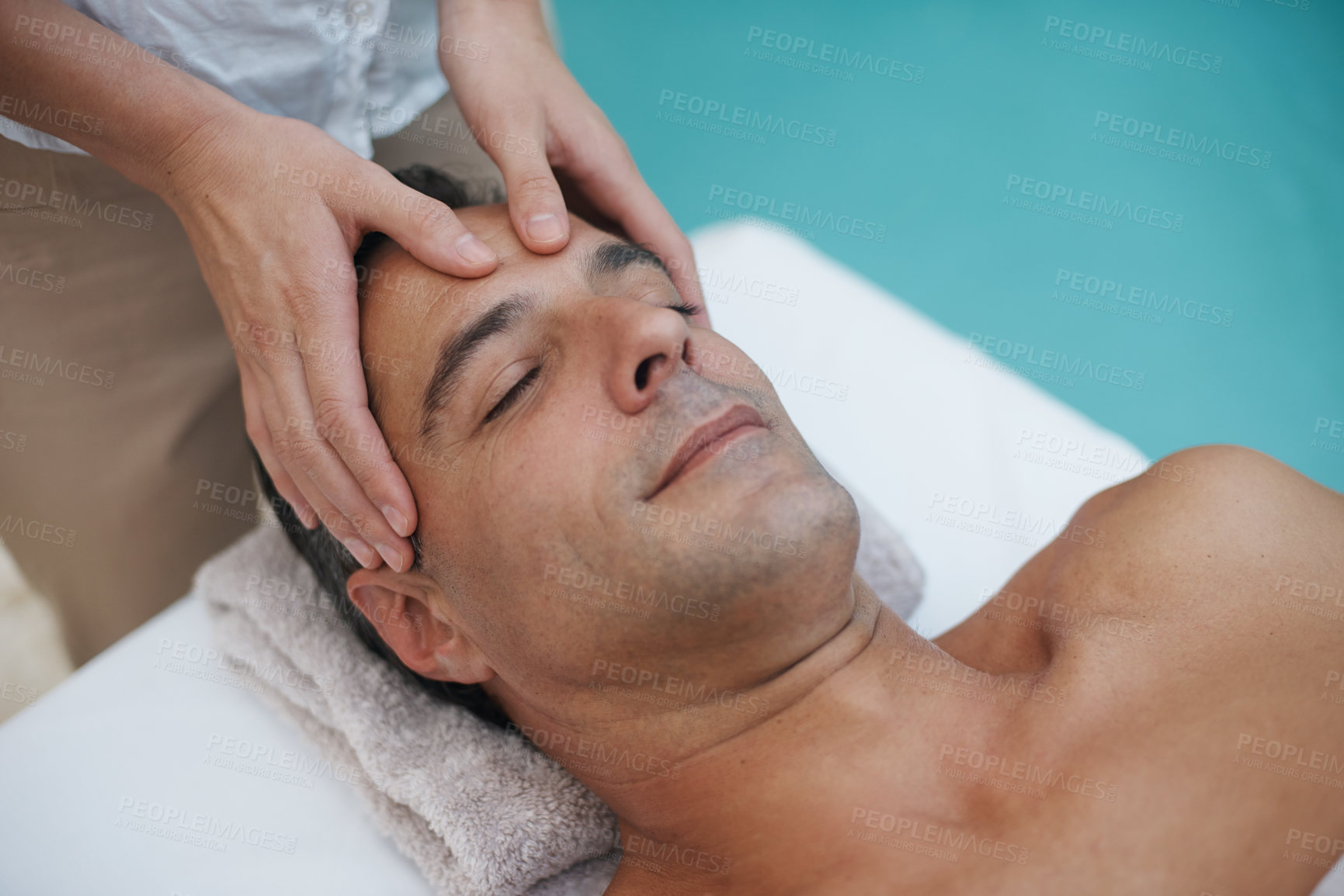 Buy stock photo Resort, spa and man relax for massage on table in hotel, calm and care for body in vacation. Holiday, luxury and male person on break for weekend, accommodation and lodge with treatment for skincare