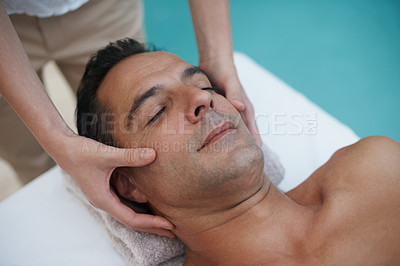 Buy stock photo Outdoor, spa and man relax for facial massage on table in hotel, calm and care for body in vacation. Holiday, luxury and male person on break for weekend, resort and lodge with treatment for skincare