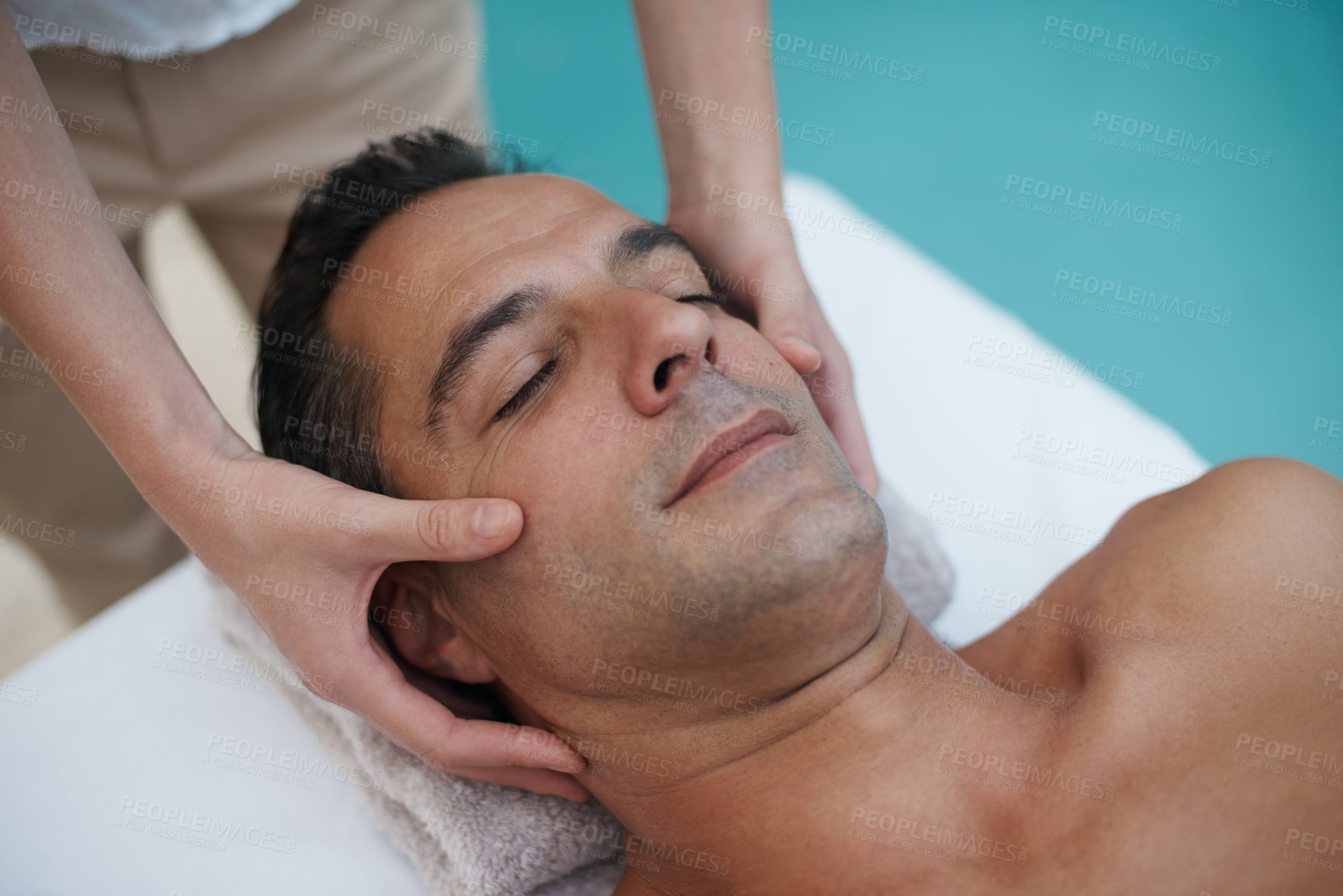Buy stock photo Outdoor, spa and man relax for facial massage on table in hotel, calm and care for body in vacation. Holiday, luxury and male person on break for weekend, resort and lodge with treatment for skincare