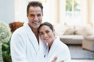 Buy stock photo Portrait, robe and couple at hotel with embrace, smile and relax together at wellness spa holiday. Hospitality, happy woman and man hug at luxury villa for travel, vacation and love on romantic date