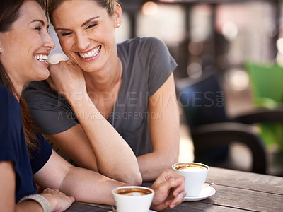 Buy stock photo Cropped shot of two attractive women laughing while drinking coffee