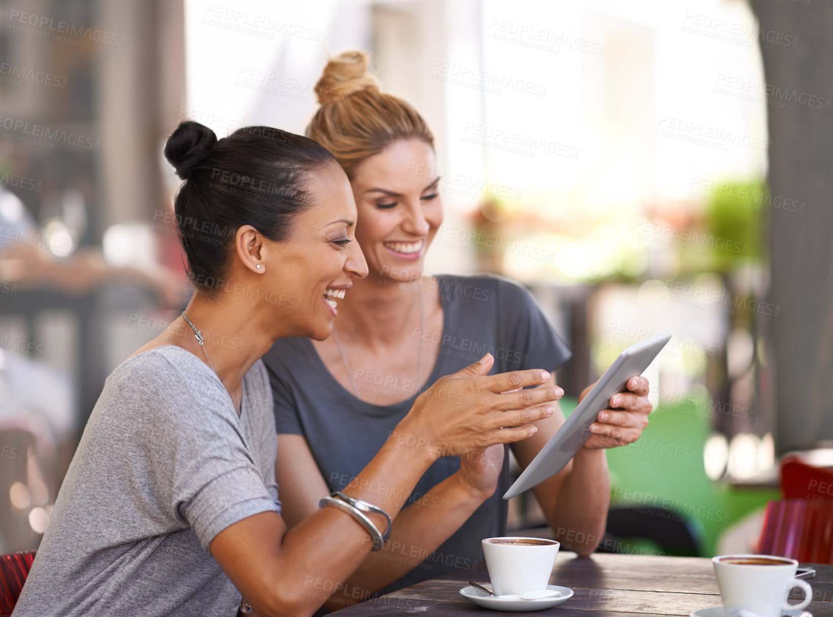 Buy stock photo Coffee shop, women and smile together with tablet for social media meme or online joke, video and bonding for friendship. Female friends, digital technology and browse internet, website and outdoors.