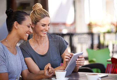 Buy stock photo Coffee shop, women and laugh together with tablet for social media meme or online joke, video and bonding for friendship. Female friends, digital technology and browse internet, website and outdoors.