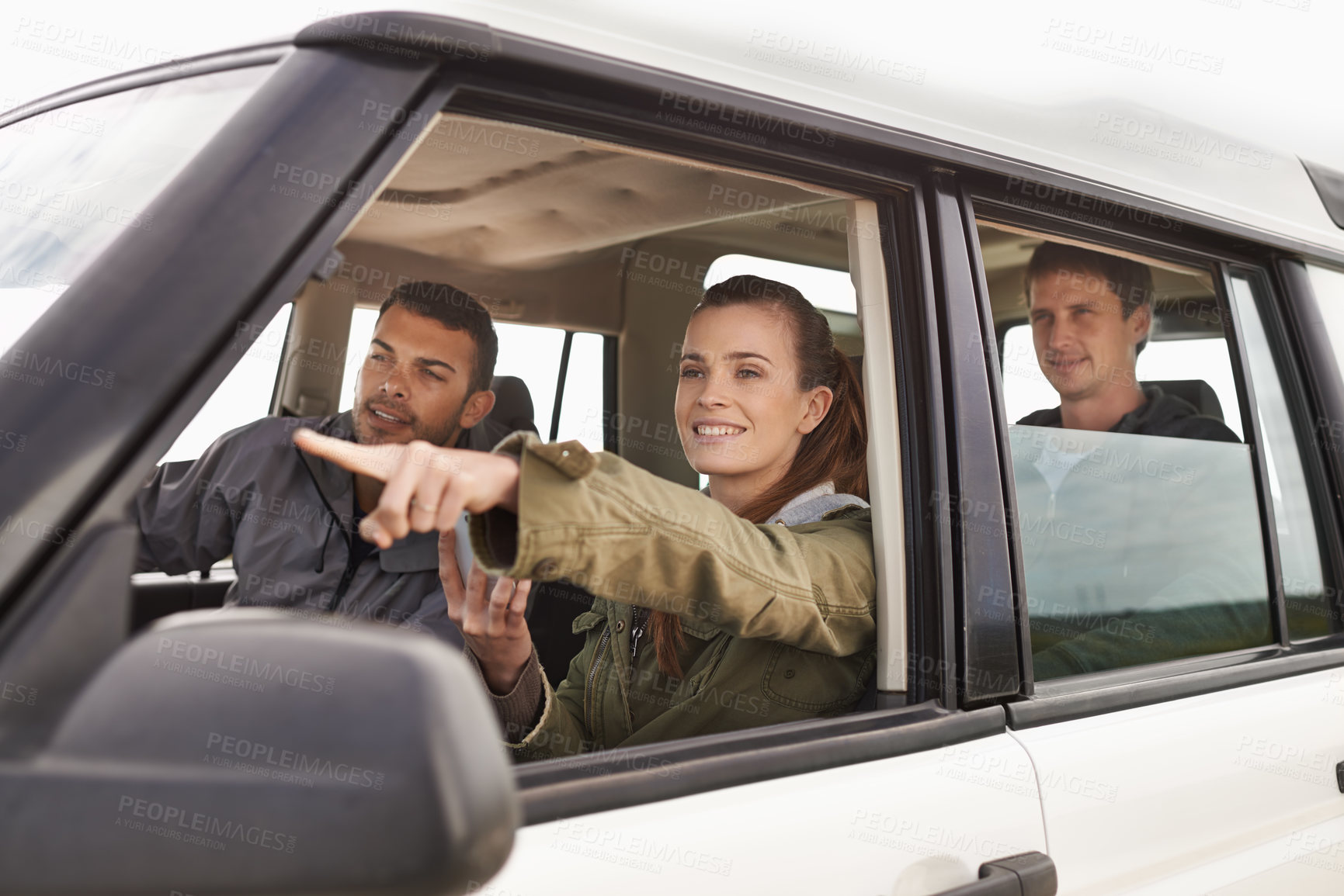 Buy stock photo Friends, car and pointing on road trip with travel for adventure, vacation and sightseeing with happiness in countryside. Woman, men and driving in vehicle for holiday journey, tourism and scenery