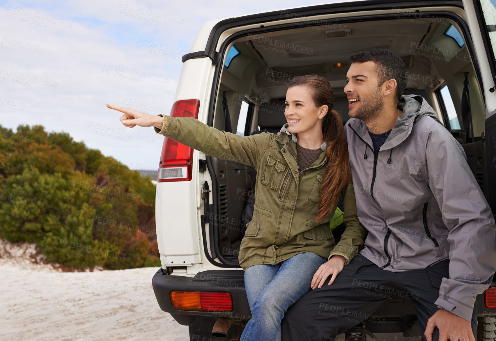 Buy stock photo Couple, car and pointing on road trip with relax for adventure, vacation and sightseeing with happiness in countryside. Woman, men or travel in vehicle for holiday journey, tourism or outdoor scenery