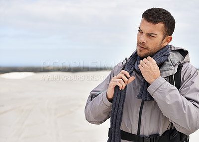 Buy stock photo Man, hiking and walking on sand dunes for fitness adventure, desert and extreme sport in arid climate. Athlete, thinking and survival gear for nature exploration, jacket and idea in outdoor in dubai