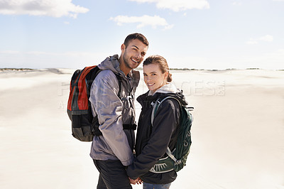 Buy stock photo Hiking, sand dunes and couple in portrait for adventure, desert landscape and travel on holiday. Holding hands, explorers and happy nomad people in Sahara terrain, outdoor or dry climate for love